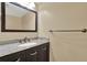 Bathroom vanity featuring dark wood cabinets and granite countertop at 9649 Water Fern Cir, Clermont, FL 34711