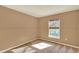 Neutral bedroom with carpeted floors, a window with blinds, and neutral walls at 9649 Water Fern Cir, Clermont, FL 34711