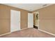 Neutral bedroom with carpeted floors, neutral walls, and two white doors at 9649 Water Fern Cir, Clermont, FL 34711