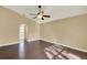 Bright bedroom featuring hardwood floors and ceiling fan at 9649 Water Fern Cir, Clermont, FL 34711