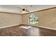 Living room features hardwood flooring and windows offering natural light and a view of the landscape at 9649 Water Fern Cir, Clermont, FL 34711