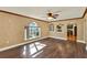 Living room showcases dark hardwood floors, decorative arched windows, and open access to other rooms at 9649 Water Fern Cir, Clermont, FL 34711