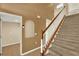 Carpeted staircase with wooden handrail and white spindles at 9649 Water Fern Cir, Clermont, FL 34711