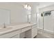 Bright bathroom with double vanity, large mirror, tiled shower, and natural light at 10359 Ebb Tide Ln, Orlando, FL 32821