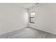 Simple bedroom featuring neutral carpet and a bright window at 10359 Ebb Tide Ln, Orlando, FL 32821