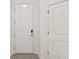 Clean and bright entryway featuring a white door with smart lock at 10359 Ebb Tide Ln, Orlando, FL 32821