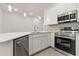 Well-equipped kitchen featuring stainless steel appliances, quartz countertops, and custom cabinetry at 10359 Ebb Tide Ln, Orlando, FL 32821