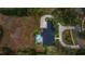 Aerial view of property with a pool, lush landscaping, and a private driveway at 1080 Edmiston Pl, Longwood, FL 32779