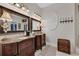 Bathroom with double vanity, granite countertops, and decorative mirror at 1080 Edmiston Pl, Longwood, FL 32779