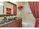 Bathroom with granite counter, carved wood cabinet and bathtub shower combo at 1080 Edmiston Pl, Longwood, FL 32779