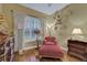 Cozy bedroom with hardwood floors, window with shutters, and comfortable seating at 1080 Edmiston Pl, Longwood, FL 32779