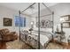 Bedroom featuring a four poster bed, a leather chair and hardwood floors with area rug at 1080 Edmiston Pl, Longwood, FL 32779