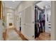 Hallway leading to a walk-in closet and featuring hardwood floors, and white trim at 1080 Edmiston Pl, Longwood, FL 32779