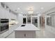 Bright kitchen with white cabinets, marble countertops, a large island, and modern stainless steel appliances at 1080 Edmiston Pl, Longwood, FL 32779