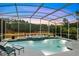 Enclosed pool area with a jacuzzi and elegant landscaping at 1080 Edmiston Pl, Longwood, FL 32779