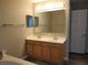 Bathroom featuring a double sink vanity with modern fixtures and a large mirror at 115 Royalty Cir, Sanford, FL 32771