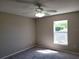 Bedroom with neutral walls and carpet, plus a large window at 115 Royalty Cir, Sanford, FL 32771