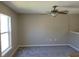 Bedroom featuring plush gray carpeting, a ceiling fan, and a bright window at 115 Royalty Cir, Sanford, FL 32771