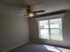 Bright bedroom featuring a ceiling fan and a window providing natural light at 115 Royalty Cir, Sanford, FL 32771