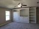 Bedroom featuring plush gray carpeting and custom built-in shelving and storage at 115 Royalty Cir, Sanford, FL 32771