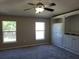 Bedroom featuring plush gray carpeting, a ceiling fan, and built-in shelving units at 115 Royalty Cir, Sanford, FL 32771