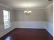 Formal dining room featuring classic wainscoting, crown molding, and gleaming hardwood floors at 115 Royalty Cir, Sanford, FL 32771