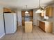 Traditional eat-in kitchen featuring an island, white appliances, and ample cabinet space at 115 Royalty Cir, Sanford, FL 32771