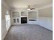 Comfortable living room featuring a fireplace, built-in shelving, and neutral carpet at 115 Royalty Cir, Sanford, FL 32771