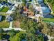 Aerial view of a property showcasing mature trees and landscaping, with surrounding neighborhood homes visible at 120 Lake Dr, Oviedo, FL 32765