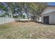 Backyard showing grass and fence with a garage and storage shed at 120 Lake Dr, Oviedo, FL 32765