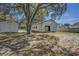 Backyard featuring a storage shed and the side of the garage with a fence at 120 Lake Dr, Oviedo, FL 32765