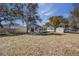 Large backyard featuring mature trees, a storage shed, and ample space for outdoor activities at 120 Lake Dr, Oviedo, FL 32765