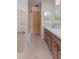 Bathroom featuring dual sinks, a shower and bathtub, and a wooden door at 120 Lake Dr, Oviedo, FL 32765