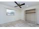 Bedroom showcasing a ceiling fan, a window and a closet for storage at 120 Lake Dr, Oviedo, FL 32765