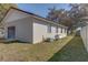 Exterior shot showing the side of the garage with windows and a fenced yard at 120 Lake Dr, Oviedo, FL 32765