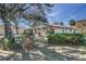 Home exterior featuring stone accents, landscaping, and a well-maintained yard with flowering plants at 120 Lake Dr, Oviedo, FL 32765