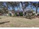 Attractive single-story home featuring stone details and mature trees at 120 Lake Dr, Oviedo, FL 32765