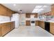 Traditional kitchen with wood cabinets, white appliances, and a large skylight at 120 Lake Dr, Oviedo, FL 32765