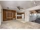 Open-concept living room with wood paneled wall open to kitchen at 120 Lake Dr, Oviedo, FL 32765