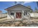 Exterior of a block outbuilding with double doors, offering potential for workshop or storage at 120 Lake Dr, Oviedo, FL 32765