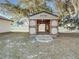 Exterior view of the storage shed with large, open doors and a ramp at 120 Lake Dr, Oviedo, FL 32765