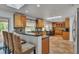 Bright kitchen with light wood cabinets, granite counters, skylight, tile floors, and breakfast bar seating at 137 Tangerine Ave, Oviedo, FL 32765