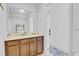 Bright bathroom featuring a wooden vanity, sink, and a large mirror, creating a clean and inviting space at 1371 Captiva Cv, Sanford, FL 32771