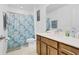 Bathroom featuring a vanity with a sink, a toilet, and a shower behind a patterned blue shower curtain at 1371 Captiva Cv, Sanford, FL 32771