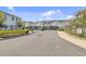 Gated community entrance featuring black iron gates, sidewalks, landscaping, and several two-story residential buildings at 1371 Captiva Cv, Sanford, FL 32771