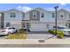 Charming townhome exterior with a paved driveway, colorful facade, and well-maintained landscaping at 1371 Captiva Cv, Sanford, FL 32771