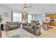 Comfortable living room featuring two sofas, an area rug, and views into the kitchen and dining area at 1371 Captiva Cv, Sanford, FL 32771