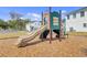 Community playground with a slide and play structure surrounded by wood chip safety ground cover at 1371 Captiva Cv, Sanford, FL 32771