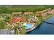 Aerial view of a community featuring a lake, pool, clubhouse, and playground at 141 Pompano Beach Dr, Kissimmee, FL 34746