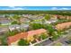 Aerial view of townhomes with red tile roofs in a community with lush landscaping at 141 Pompano Beach Dr, Kissimmee, FL 34746